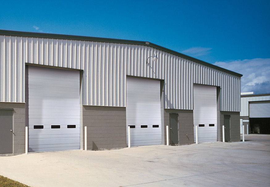 white garage doors with windows on commercial building