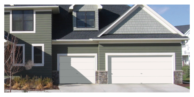 Green house with white garage doors